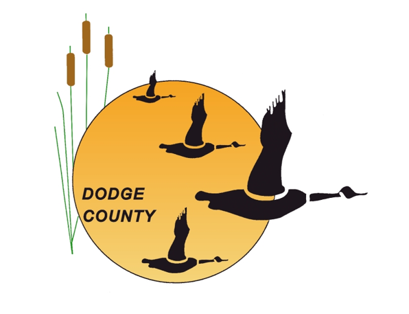 Logo featuring four silhouetted geese flying in front of a large orange sun with the words ‘Dodge County’ on it.
                        Tall cattails stand to the left of the sun.